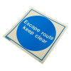 angled view of escape route keep clear sign made of rigid plastic with blue circle and white text