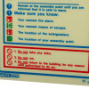 Closeup of fire action sign with safety instructions about assembly points, fire alarms, means of escape, and risks not to take