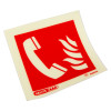 closeup of a fire telephone sign showing a white telephone handset and flames on a red square background