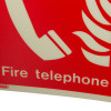 Closeup of fire telephone panoramic sign with white telephone icon and text on a red background