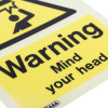Close up of a warning mind your head sign printed on rigid plastic with black text on yellow background