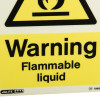 Closeup of a warning flammable liquid sign showing black text and a flame symbol on a yellow background