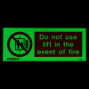 Lift prohibited sign glowing green with text Do not use lift in the event of fire and a no entry symbol