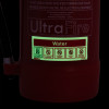 glow in dark close up of water self adhesive sticker on a dark red surface with safety symbols visible