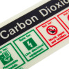 Close up of carbon dioxide fire extinguisher self adhesive sticker showing safety and hazard symbols in green and red
