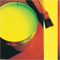 Photoluminescent heavy duty floor marking paint in an open can next to a brush on a brightly coloured surface