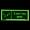 Glowing designaated smoking area table top sign with smoking symbol and text on a dark background