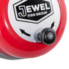 Closeup of the handle and label on the jewel rotary hand bell showing part of the red casing and black knob