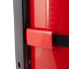 Closeup back view of heavy duty extinguisher transport bracket showing black strap and red clip on red surface