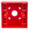 A front-facing view of a red surface‑mounting call point back box, showing multiple mounting slots, screw terminals, and a central circular opening.