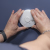 Kidde 10Y29 10 Year Optical Smoke Alarm being held and fitted by hands on a blue ceiling