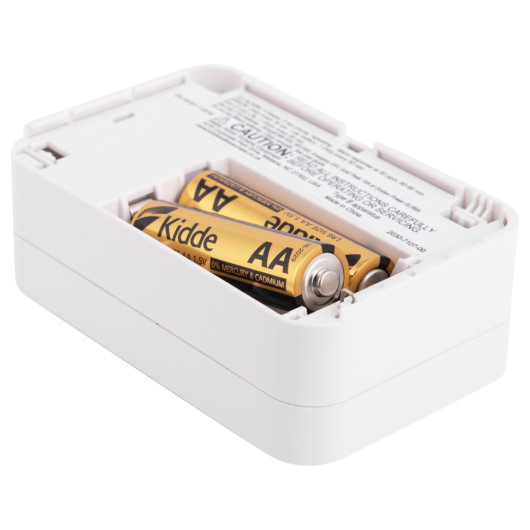 carbon monoxide alarm showing the battery compartment with two AA batteries inside