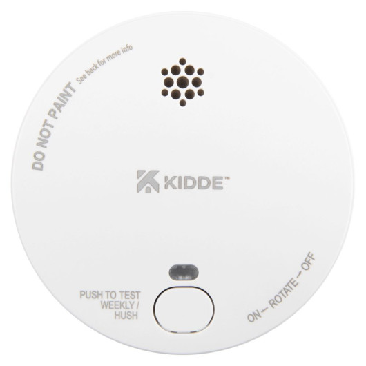 Front view of a round smoke alarm with a test button and ventilation holes visible