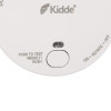 Close up of the test hush button on a smoke alarm showing text and switch details