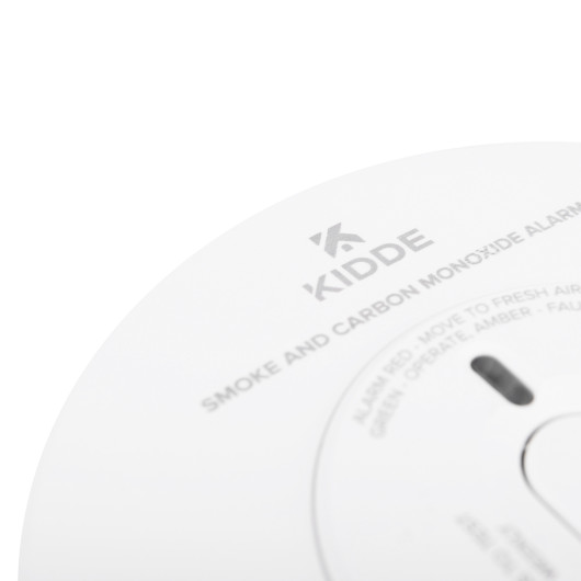 Closeup detail of the Kidde combination smoke carbon monoxide alarm showing part of the logo and text on its surface