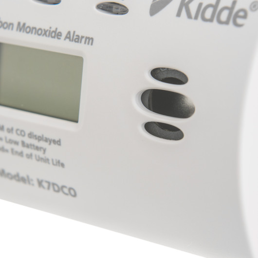 Closeup of the sounder vents on a Kidde co digital alarm showing part of the display and casing