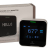mains powered carbon dioxide monitor with digital display alongside its white and brown box showing the product name