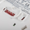 Back closeup of kidde firex mains powered optical smoke alarm self charging lithium battery backup showing warning labels and connection points