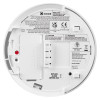 The rear of a Kidde KF21 smoke alarm displaying printed safety information, certification markings, wiring details and a battery compartment.