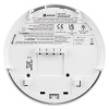 The rear of a Kidde KF21R smoke alarm displaying printed safety information, certification markings, wiring details and a battery compartment.