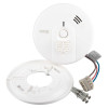 Kidde Firex mains powered heat alarm self charging lithium battery backup shown with its round white backing plate