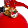 Close-up of the pressure gauge and handle on the kidde 2kg powder extinguisher showing the dial and securing pin