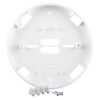 A white circular alarm mounting base shown with included installation accessories, including terminal blocks and two metal screws placed in front of the base.