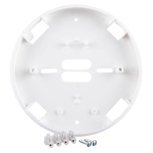 A white circular alarm mounting base shown with included installation accessories, including terminal blocks and two metal screws placed in front of the base.