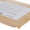 Angled close-up of an adhesive sticker pad with a brown backing and a white label visible on top