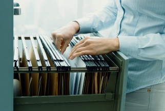 An open filing cabinet with user manuals and datasheets