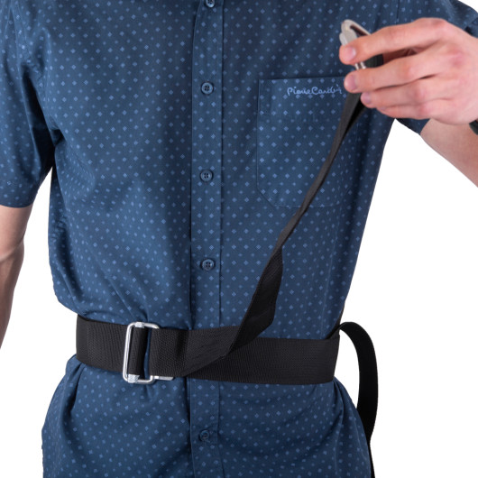 Person wearing and holding part of the modum and saffold harness showing the black strap and buckle