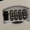 Close-up of the code lock on a master lock 5401 key safe showing four metal dials with numbers