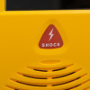Closeup of the shock button on the defibtech lifeline view semi automatic defibillator in yellow casing