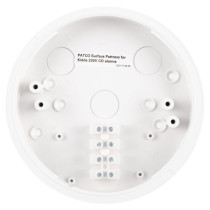 A white circular surface pattress for Kidde 230V alarms, with multiple screw holes and connection points, and an internal printed label displaying product details.