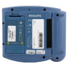 The back of a blue defibrillator showing the battery and serial numbers