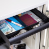 internal drawer of the phoenix titan 1281 safe showing divided compartments with watches pen passport and money