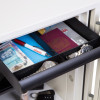 Internal drawer of phoenix titan 1281 safe showing compartments with a pen, passport, currency and two watches