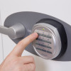 Close-up of a finger pressing a button on the electronic lock of a phoenix titan 1282 safe