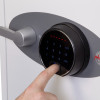 Phoenix titan 1282 safe showing a finger pressing the fingerprint lock scanner on the device