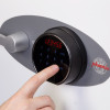 Close-up of a finger pressing the fingerprint lock on a phoenix titan 1282 safe keypad panel