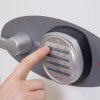 Close up of a finger pressing a button on the phoenix titan 1283 electronic lock keypad with code being entered