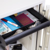 Partially open internal drawer of a phoenix titan 1283 fingerprint lock showing a pen, passport, watches and papers inside