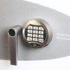 Close-up of the Phoenix Fire Commander Pro FS1921 electronic lock keypad and handle on a grey surface