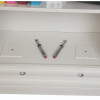Close up of the floor fixing kit for the phoenix fire commander pro fs1921 electronic lock showing two metal fittings on a white surface