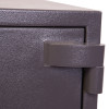 Close-up of the hinge on the phoenix mecury hs2052 security safe showing textured metal surface and joint mechanism