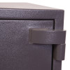 Close up of the hinge on the phoenix mercury hs2052 security safe showing textured dark metal surface