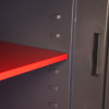 Internal shelf with bright red finish inside phoenix elara hs3552 security safe showing adjustable slots for positioning