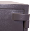 Close-up of the hinge on the phoenix elara hs3554 security safe showing textured metal surface
