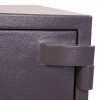 Close-up of the hinge on the phoenix elara hs3554 security safe showing textured dark metal surface
