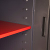 Internal shelf inside the phoenix cosmos hs9073 security safe shown in close up with red shelf and grey interior